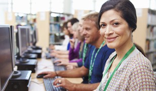 Adult female student taking a language course on computer at a Broward County South Florida community school